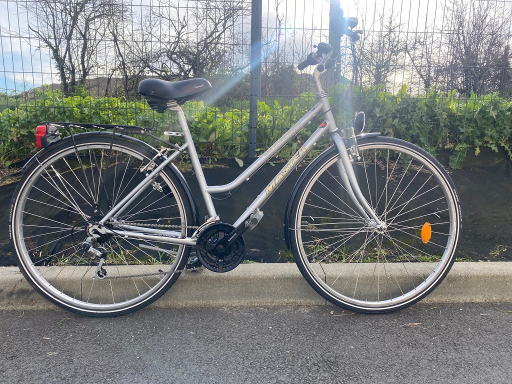 Vélo de ville photo prise au levé du soleil. Sur le cadre est écrit le nom de la ville de La Rochelle.